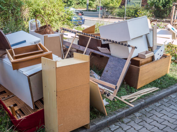 Pile of old cabinets, doors, countertops and renovation debris removed from a kitchen and set out for junk removal